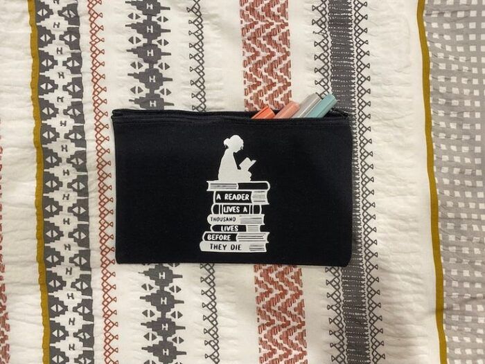 black pencil case that says a reader lives 1000 lives and never dies 