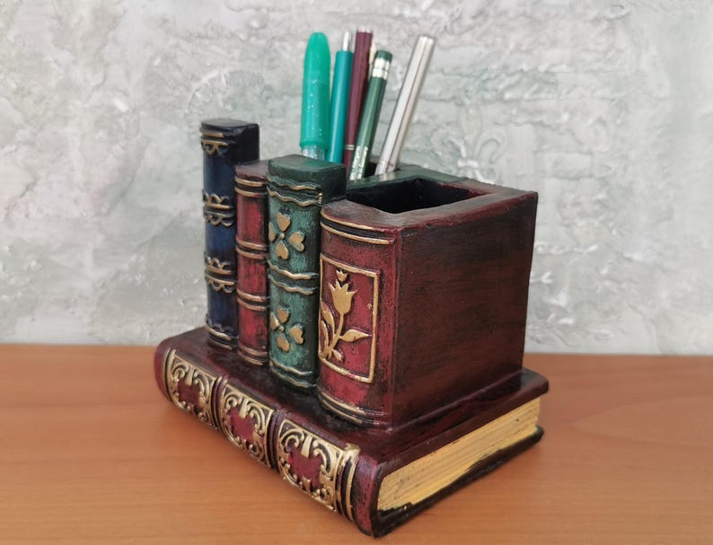 a pencil holder in the shape of a shelf of leatherbound books