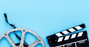 image of a film reel and clapboard on a blue background