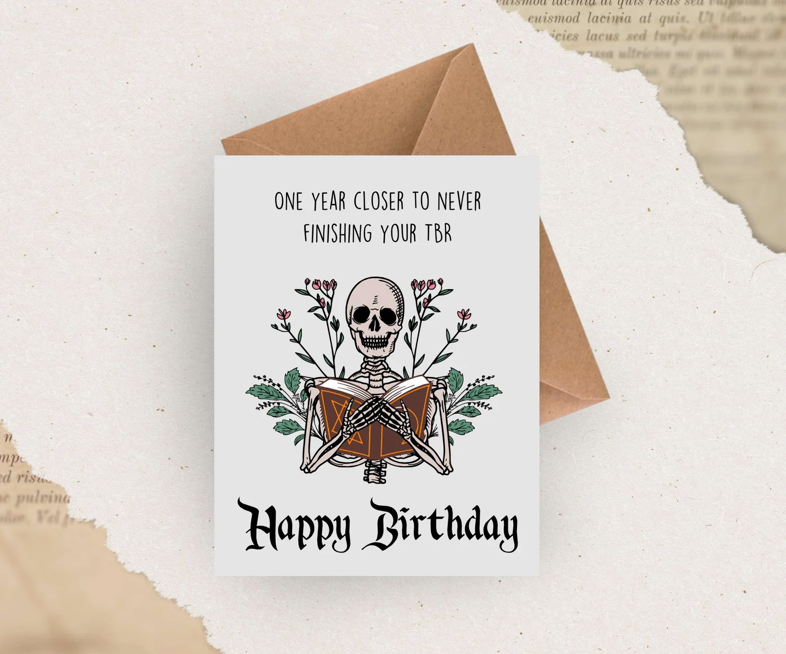 image of a birthday card that has a skeleton on it. it reads "one year closer to never finishing your tbr. happy birthday."