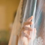 a woman looking through a bridal veil