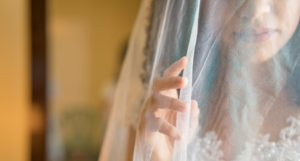 a woman looking through a bridal veil