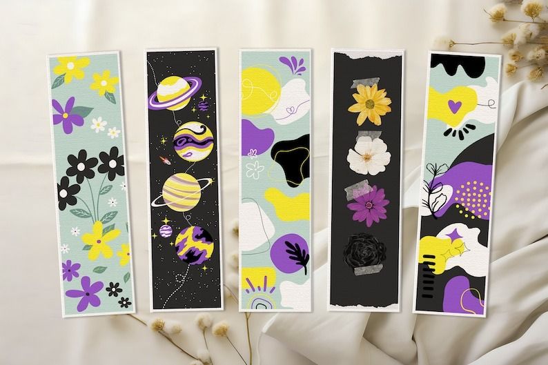 a set of bookmarks in designs using nonbinary pride flag colors