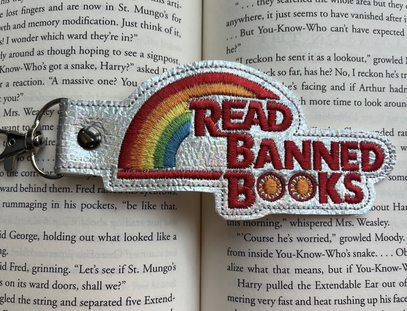 photo of an embroidered keychain with a rainbow and text "read banned books"