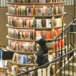 a tall column-shaped bookshelf in the middle of a library