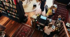 cash register and book seller helping bookstore patrons