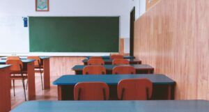 empty classroom with desks and chalk board