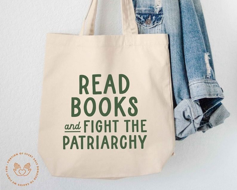 Photo of an off-white tote with the phrase "read books and fight the patriarchy" in green font screenprinted