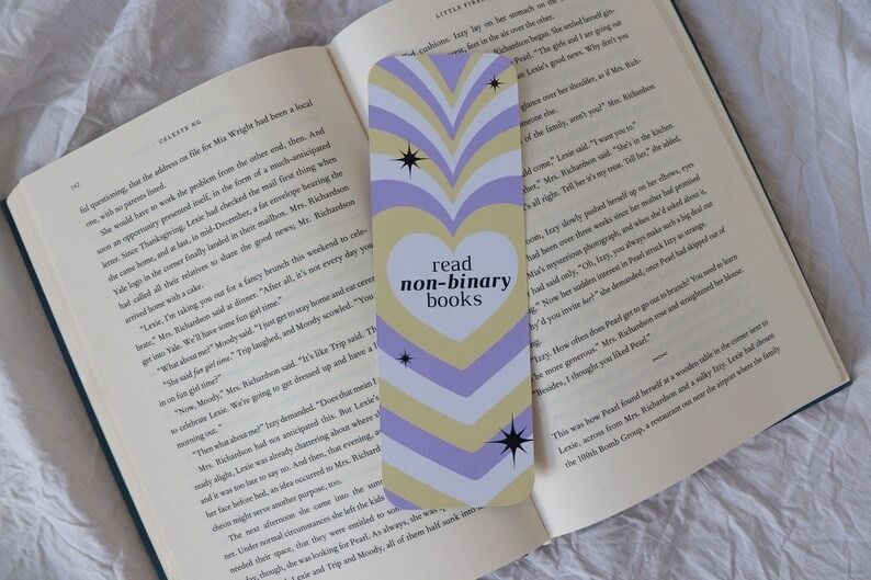 a bookmark with a heart and nonbinary pride flag colors with the text read non-binary books