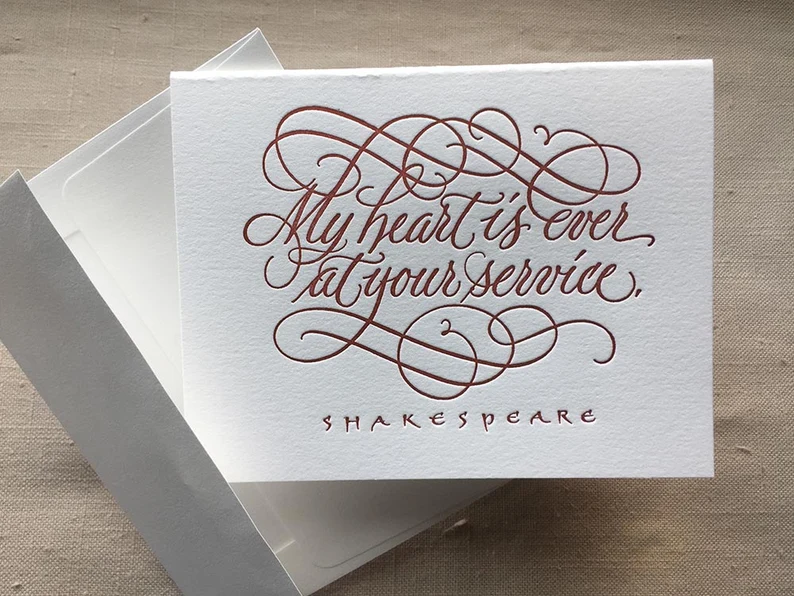 Card reading "my heart is ever at your service, shakespeare" in red calligraphy