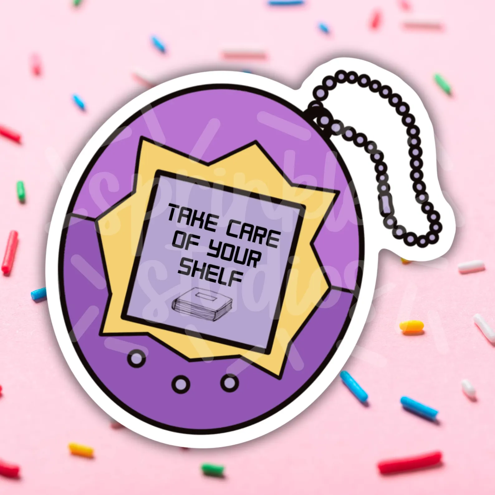 Image of a purple sticker in the shape of a Tomagatchi toy. It reads "Take care of your shelf" on the screen with a book beneath the words. 