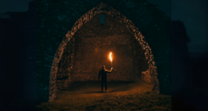 a person holding a torch in a tunnel