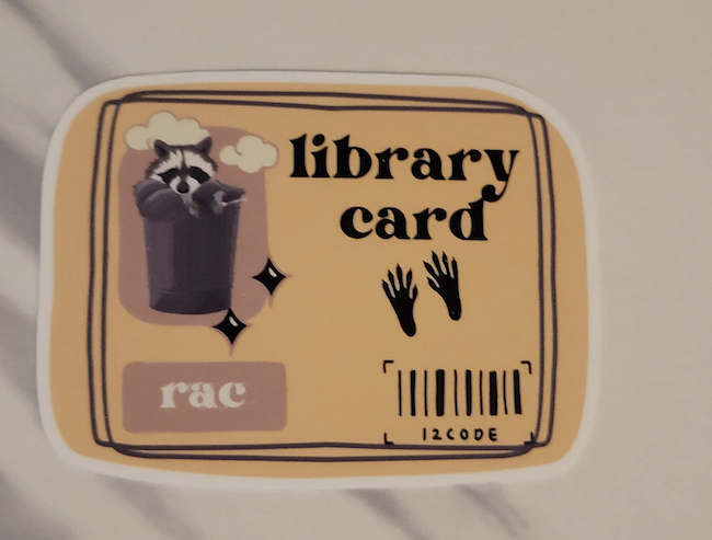 an illustrated sticker to look like a library card for a raccoon 