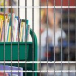 library cart behind bars image