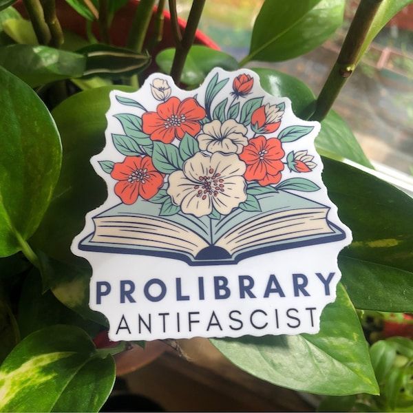 a picture of a book with flowers growing out of it with words underneath that read ":prolibrary antifascist"