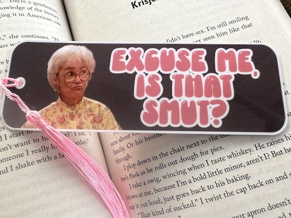 bookmark showing the scowling face of Sophia from The Golden Girls next to pink bubble text that reads "Excuse me, is that smut?"