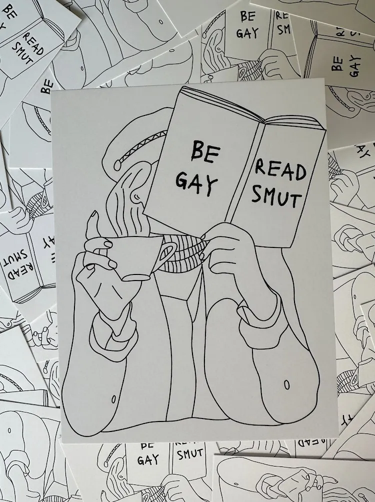 an illustrated postcard outlining a person reading reading with the book title saying "be gay read smut"