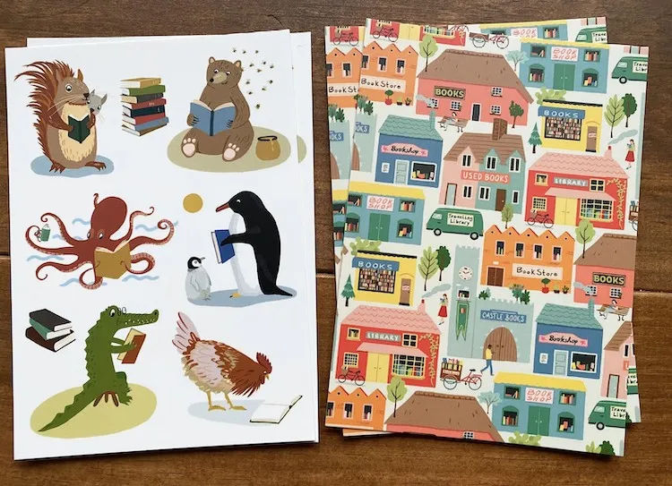 illustrated postcard set of animals reading and scenic villages with bookstores 