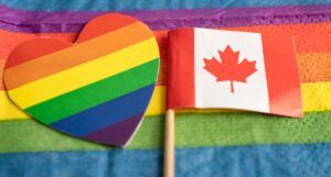 a Canadian flag and a rainbow heart