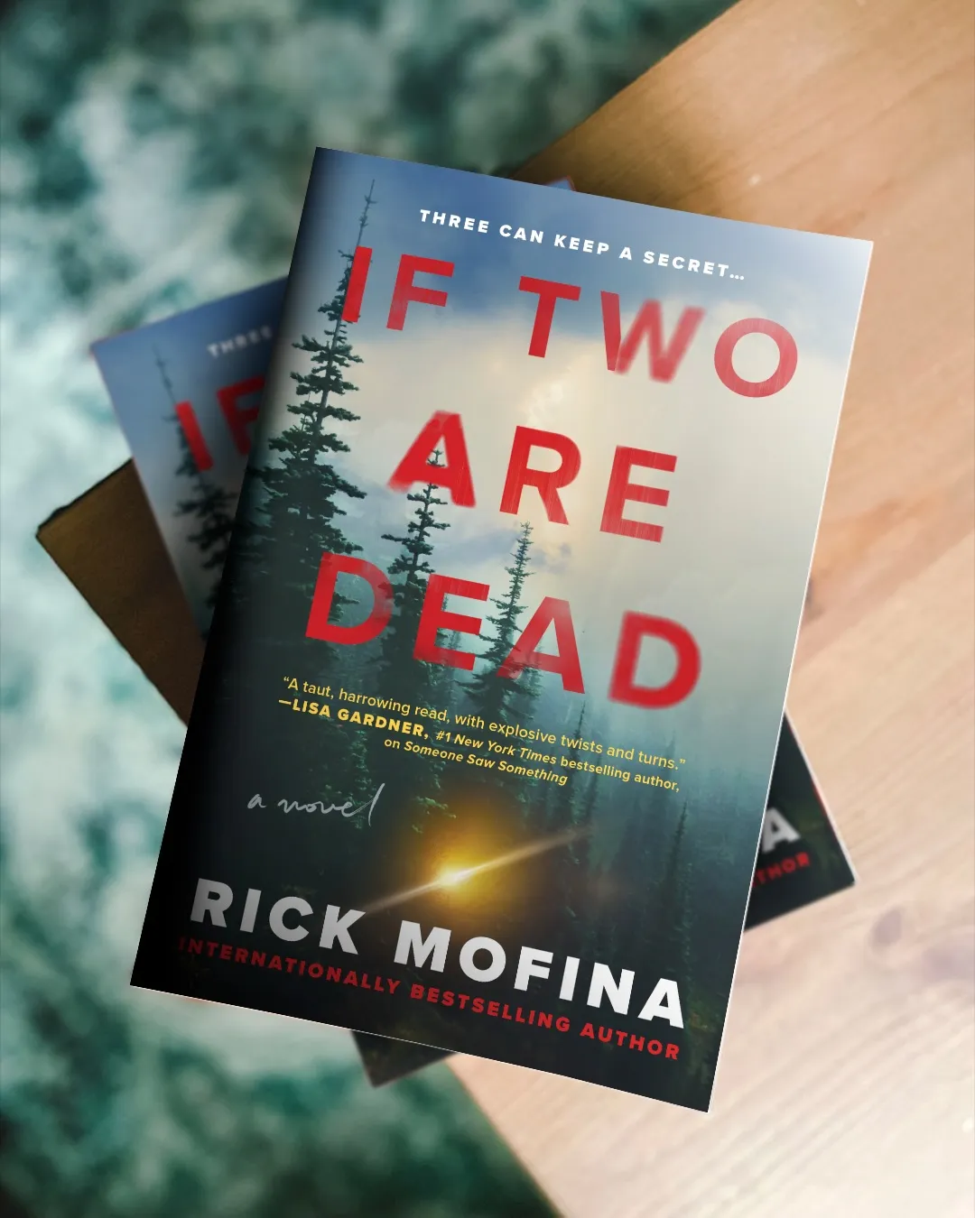 Cover of If Two Are Dead by Rick Mofina in triplet, each book stacked atop the next.