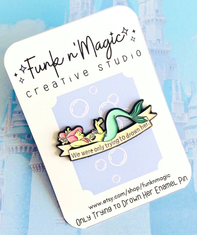 A pin with a mermaid on it