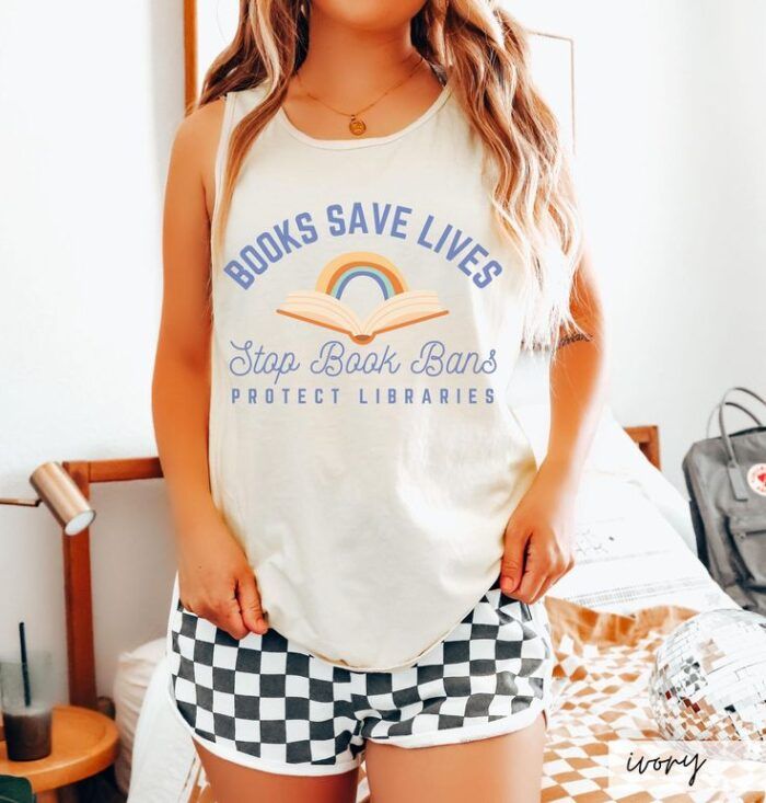 white thank with an image of an open book with a rainbow and text that reads "books save lives, stop book bans, protect libraries"