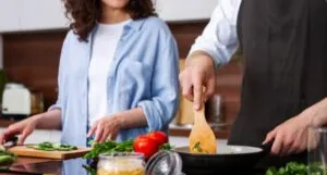 a couple cooking in a kitchen