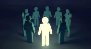 graphic of several pictograms of people forming a circle. all are dark green except for one white one