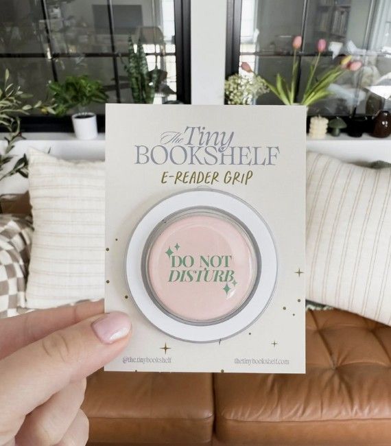 Pink pop socket with green text that says "Do Not Disturb" 