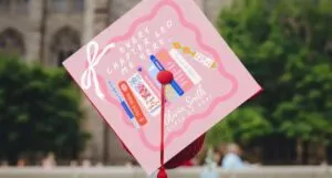 a grad cap topper with an illustration of books and the text "Every chapter led me here"