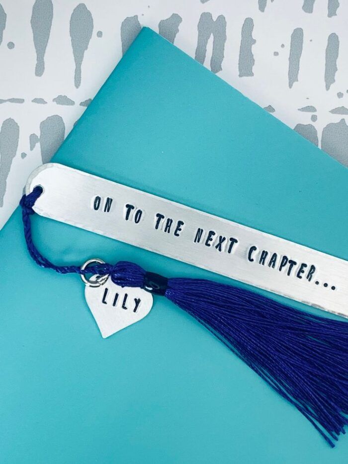 a long silver bookmark with the words 