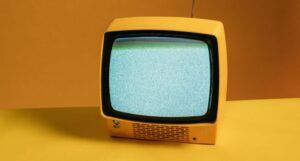 old school tv with a yellow bakground