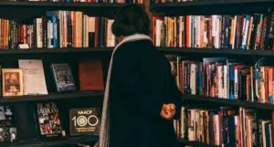 woman looking at used book shelves