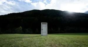 a door in the middle of a field