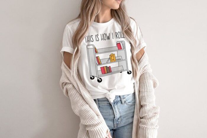 white shirt with a book trolley and the text "this is how I roll"
