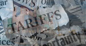 torn out paper with tariffs and related words against backdrop of shipping containers on ship