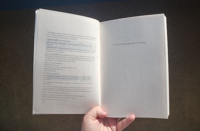 a book open to the dedication page, which is "For everyone who feels betrayed by J.K. Rowling"
