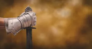 a hand holding a sword
