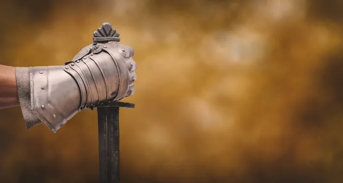 a hand holding a sword