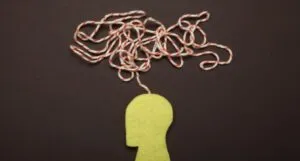 Image of a cutout person with a string coming out of its head