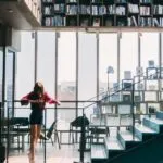 woman in Red Jacket Standing on the Stairs