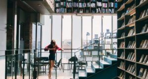 woman in Red Jacket Standing on the Stairs