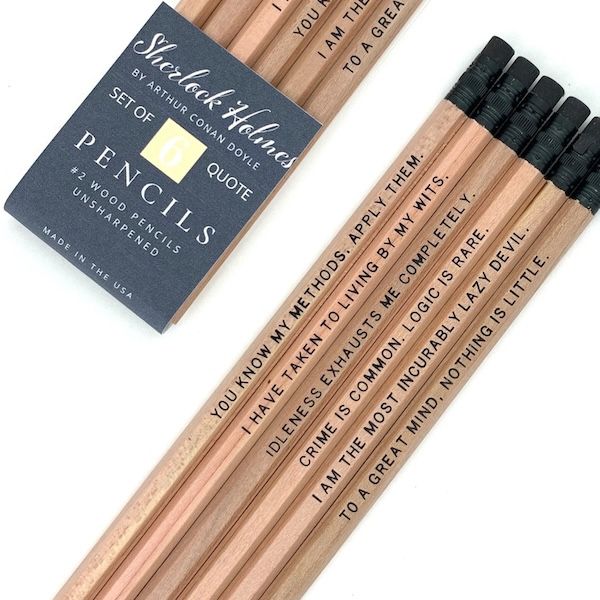 a set of six natural wood pencils, each with quotes from Sherlock Holmes in black block text