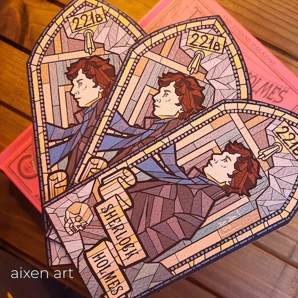 three bookmarks in a stained glass window design with 221B at the top and an image below that text of Benedict Cumberbatch as Sherlock Holmes