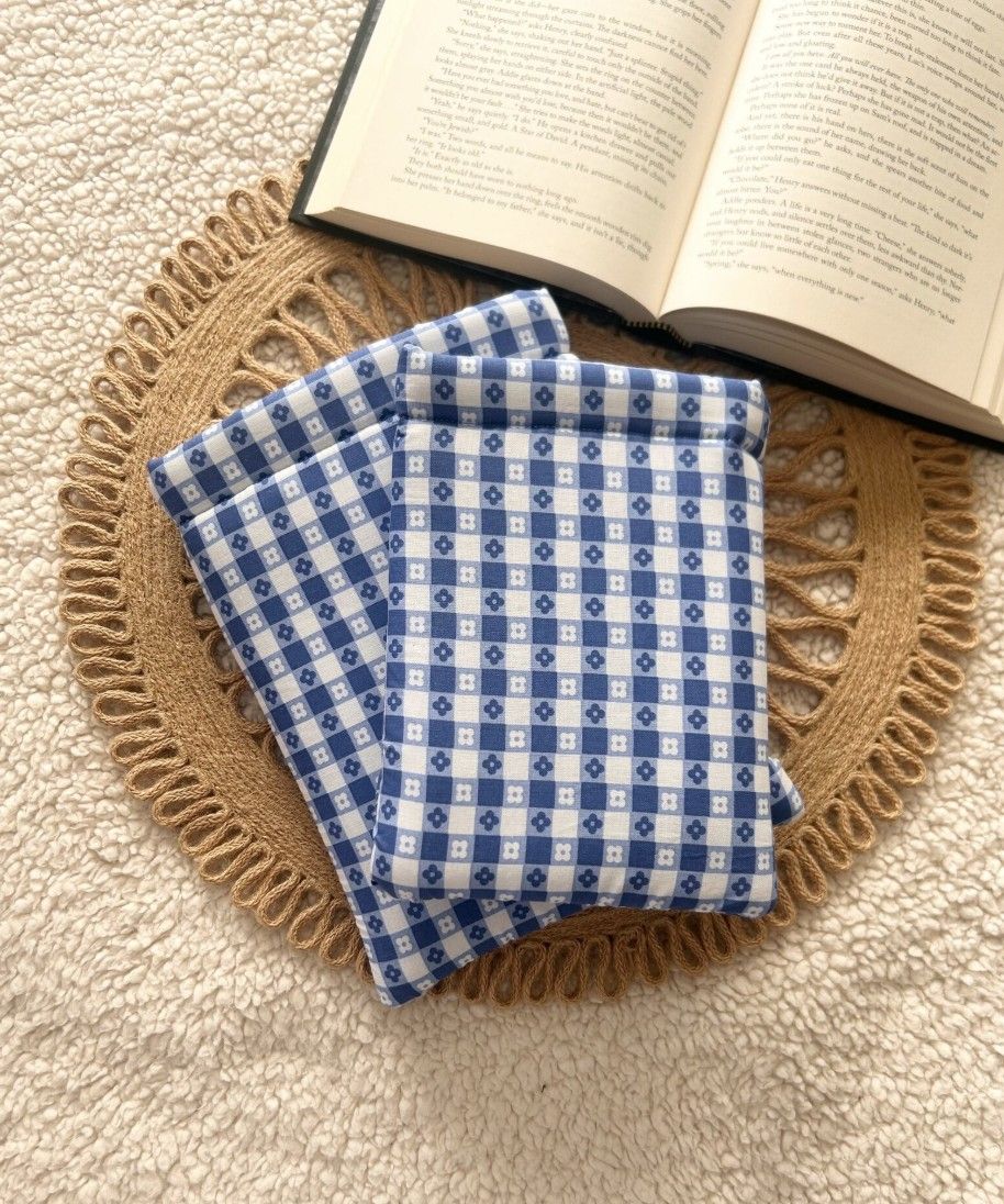 Image of two fabric book sleeves in a blue and white checkered print