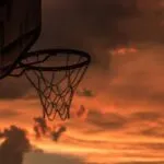 a backethall hoop at sunset