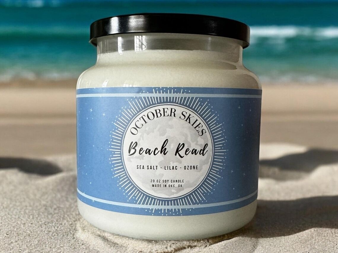 Beach Read candle posed on the beach