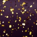 gold confetti against dark background
