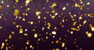 gold confetti against dark background