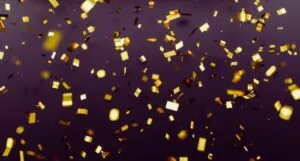 gold confetti against dark background